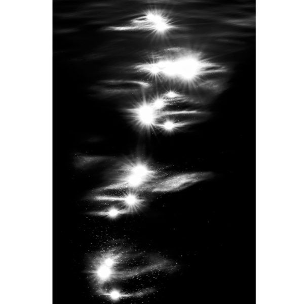 Artistic photo of reflections of light on water and constellations in black and white, by Laurent Laporte