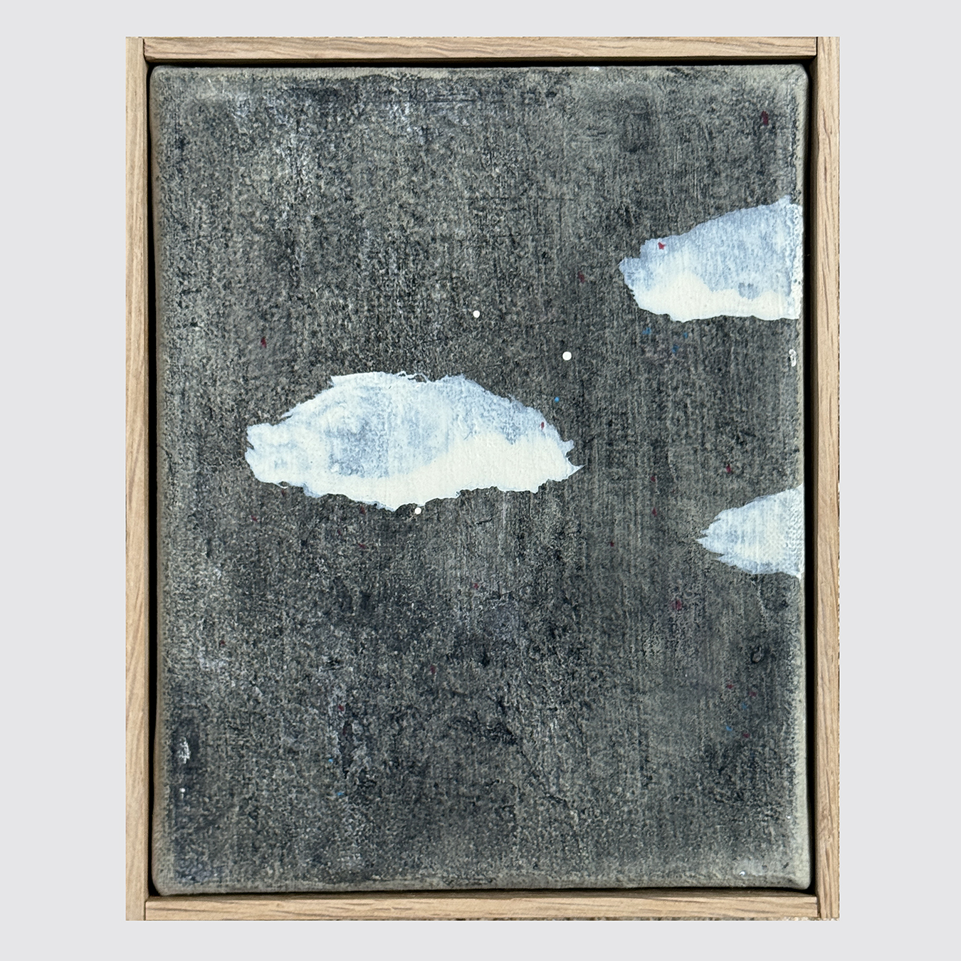 3 SMALL GREY CLOUDS ON A WHITE HORIZON